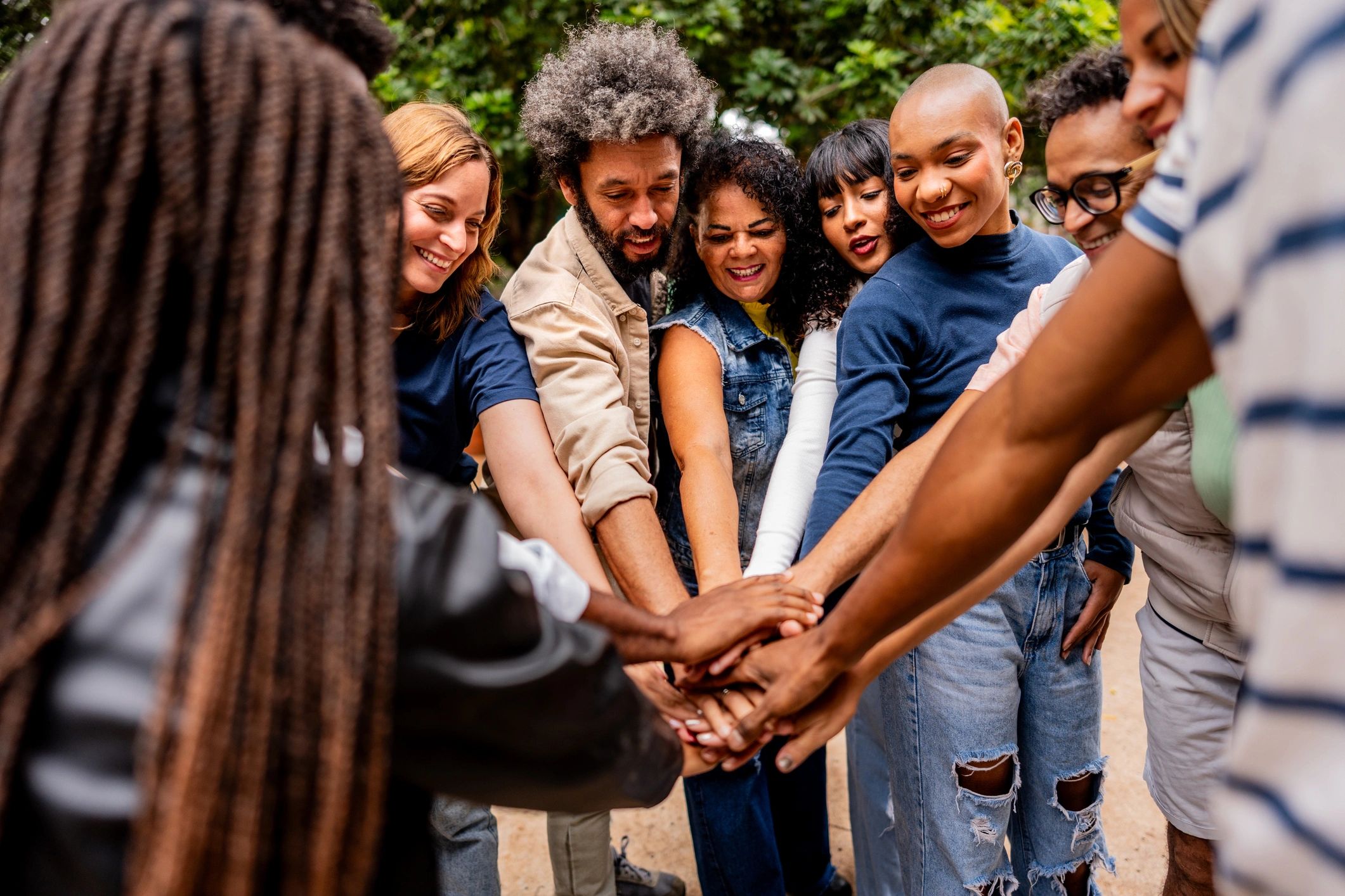 Community hands stacked together outdoors